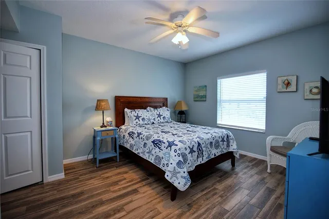 a bedroom with a bed a window and a chair