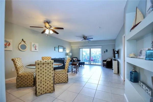 a living room with furniture a dining table and chairs