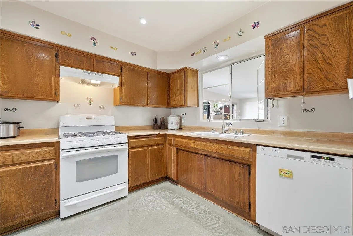 214 Summit Avenue Fallbrook, CA 92028 - Photo 12 of 43 a kitchen with a sink stove and cabinets