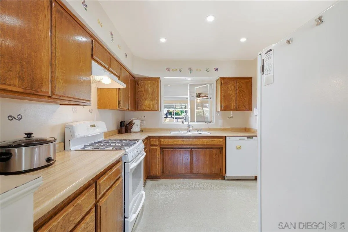 214 Summit Avenue Fallbrook, CA 92028 - Photo 14 of 43 a kitchen with stainless steel appliances granite countertop a sink stove and cabinets