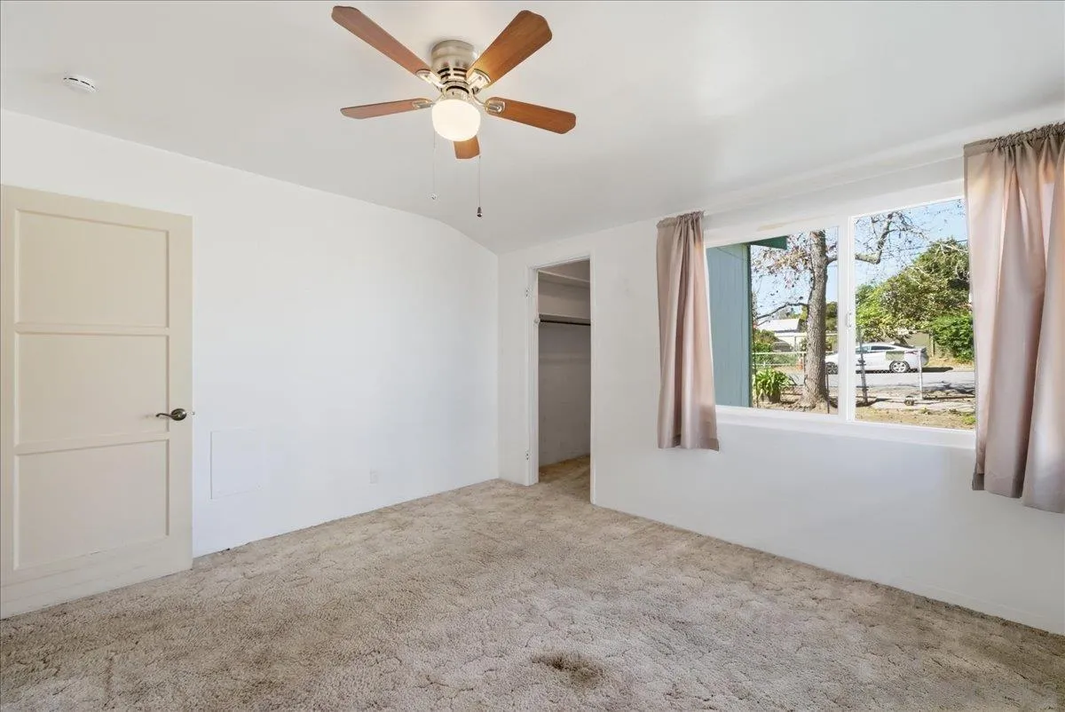 214 Summit Avenue Fallbrook, CA 92028 - Photo 33 of 43 an empty room with windows and a ceiling fan