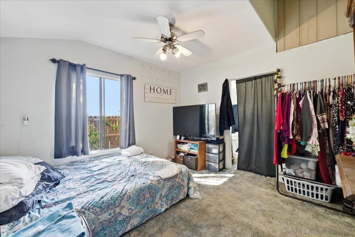 214 Summit Avenue Fallbrook, CA 92028 - Photo 43 of 43 a bedroom with a bed and a flat tv screen on dresser