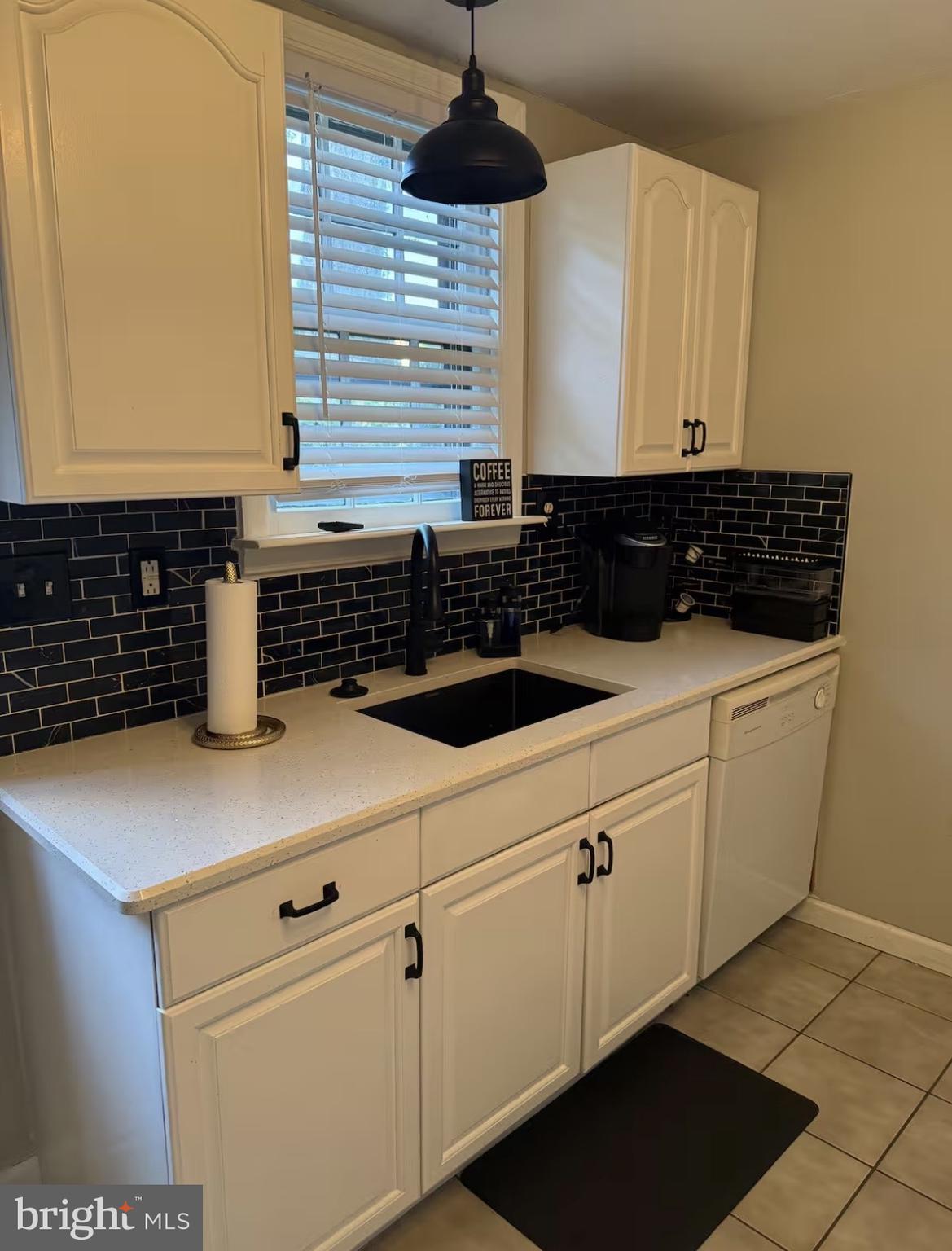 417 Delaware Street New Castle, DE 19720 - Photo 18 of 27 a kitchen with a sink and cabinets