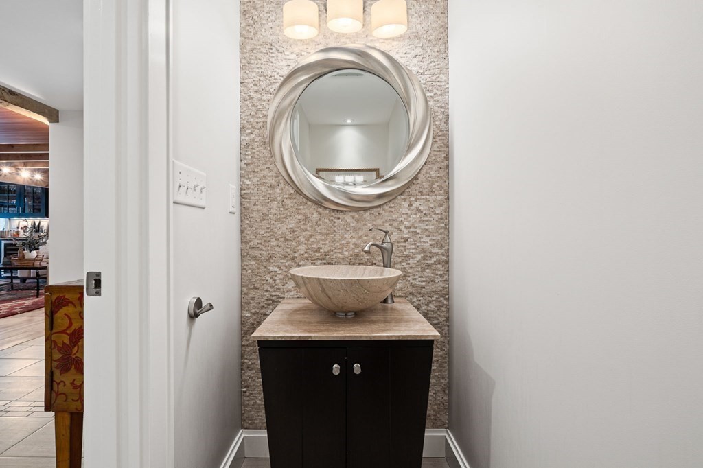 10 Grapevine Road Wenham, MA 01984 - Photo 18 of 42 a view of a utility room with a sink and a mirror