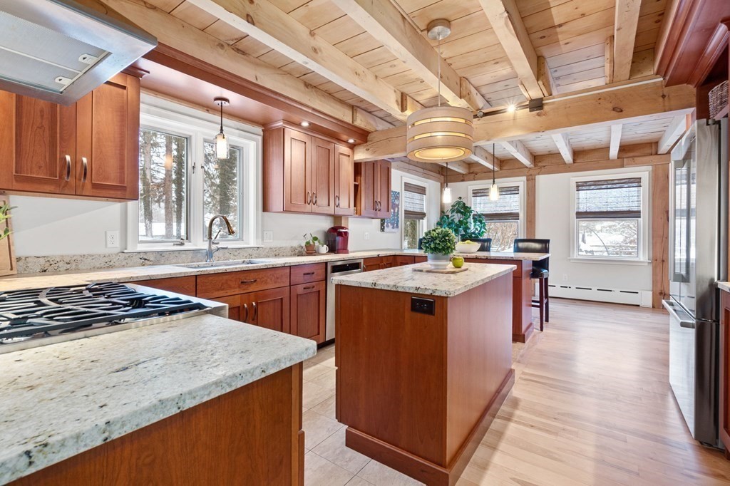 10 Grapevine Road Wenham, MA 01984 - Photo 6 of 42 a kitchen with stainless steel appliances granite countertop a sink stove and cabinets