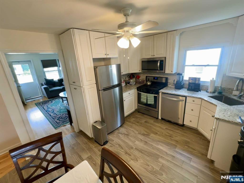 13 Jersey Avenue Mahwah, NJ 07430 - Photo 2 of 20 a kitchen with stainless steel appliances a stove refrigerator sink and microwave