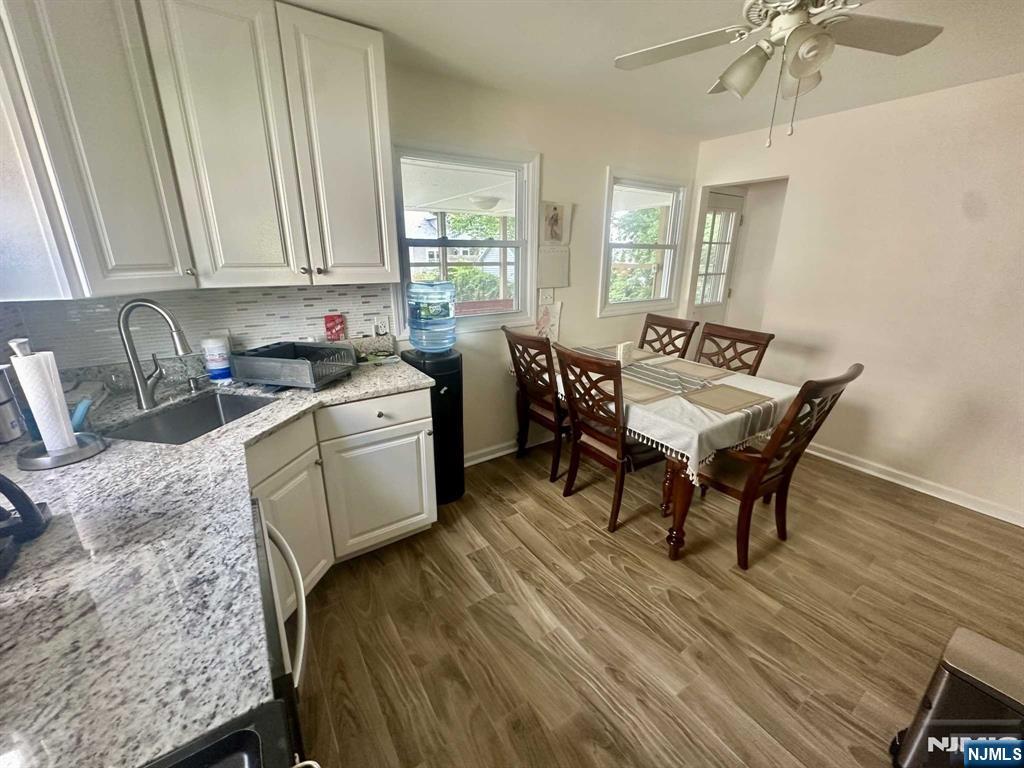 13 Jersey Avenue Mahwah, NJ 07430 - Photo 3 of 20 a kitchen with a sink a table and chairs in it
