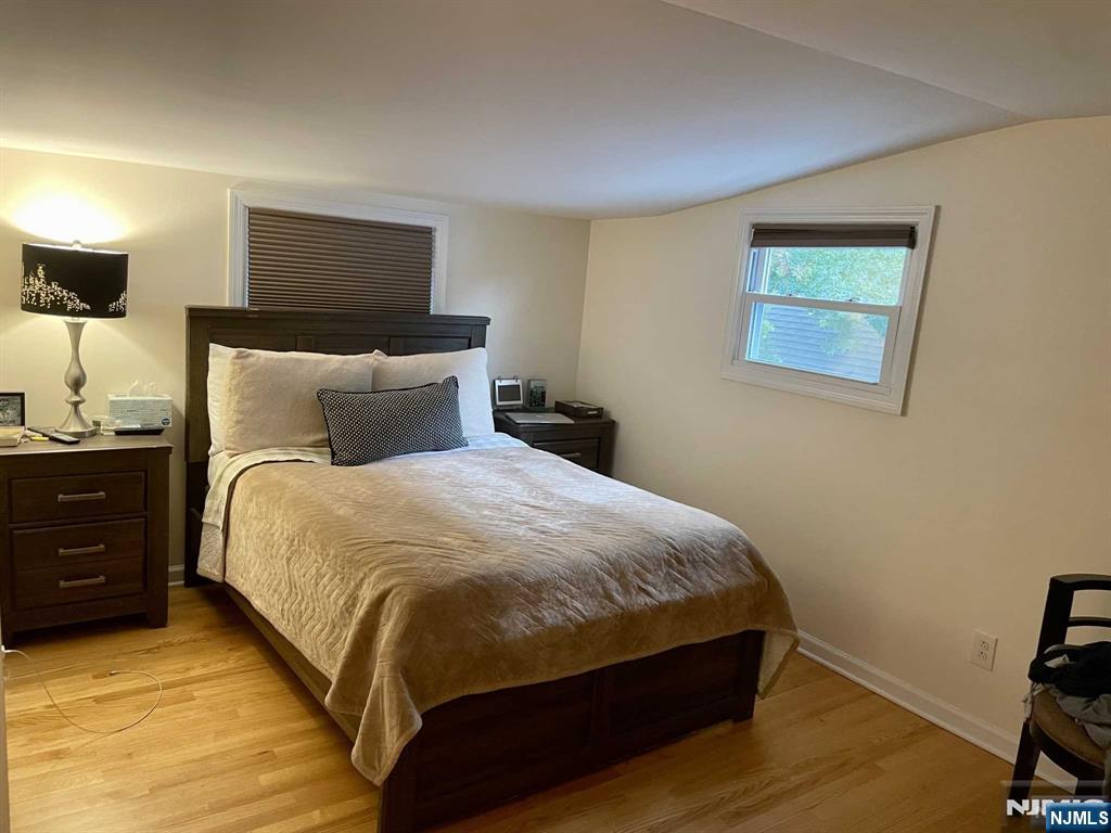 13 Jersey Avenue Mahwah, NJ 07430 - Photo 7 of 20 a bedroom with a bed and a night stand