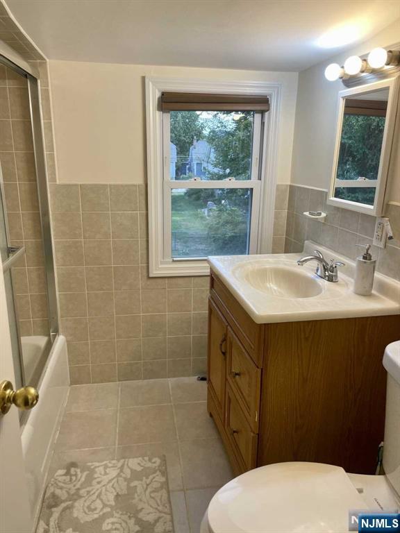 13 Jersey Avenue Mahwah, NJ 07430 - Photo 8 of 20 a bathroom with a sink a toilet a mirror and shower