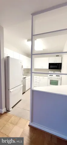 a kitchen with stainless steel appliances a stove a microwave and a refrigerator