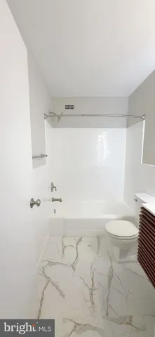 a bathroom with a toilet a sink and a shower