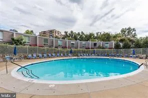 a view of swimming pool with outdoor seating and plants