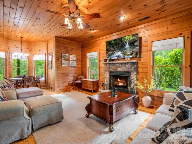 a dining room with furniture a chandelier and wooden floor