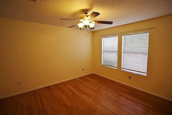 a view of a livingroom with a chandelier fan and a window