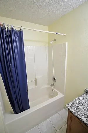 a bathroom with a shower and a bath tub