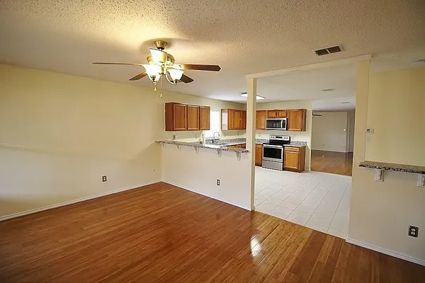 a view of a kitchen with wooden floor