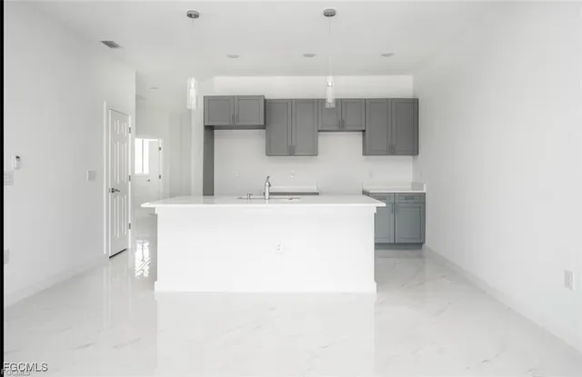 a utility room with cabinets washer and dryer