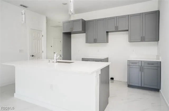 a kitchen with kitchen island cabinets and oven
