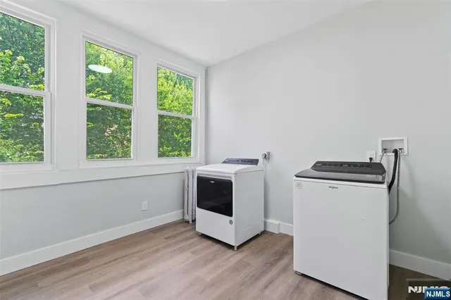 a view of a kitchen with wooden floor and electronic appliances