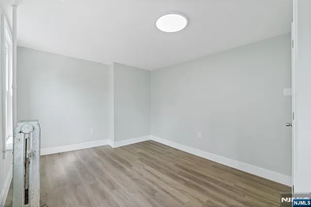 a view of room with wooden floor