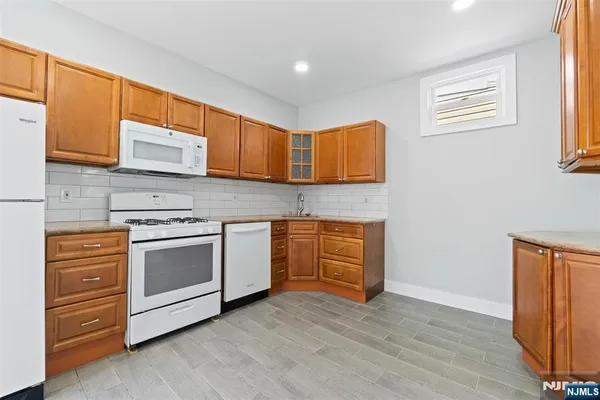 a kitchen with stainless steel appliances granite countertop a stove and a microwave