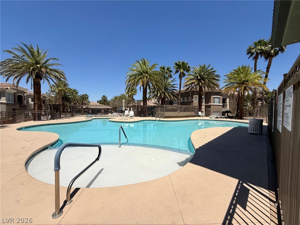 9050 West Warm Springs Road, Unit 2002 Las Vegas, NV 89148 - Photo 5 of 46 Relax and unwind by the community pool, surrounded by lush landscaping and sunshine.