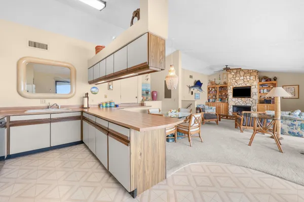 a kitchen with stainless steel appliances granite countertop a refrigerator and a stove top oven