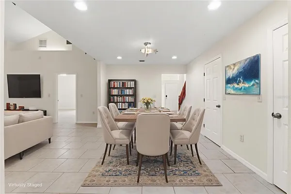 an empty room with windows and ceiling fan