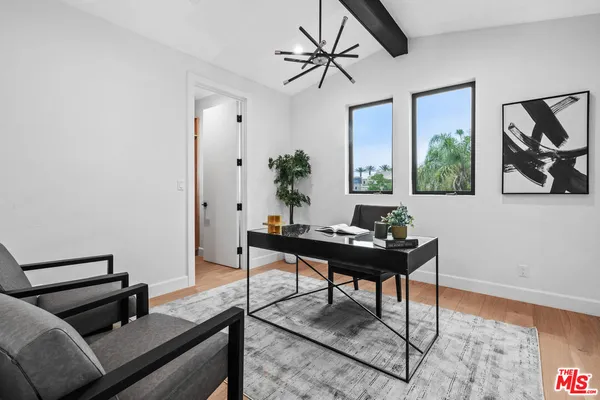 a living room with furniture a window and a potted plant