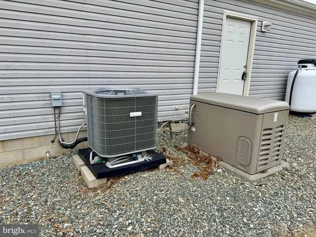 a view of a backyard with a chair and the potted plant