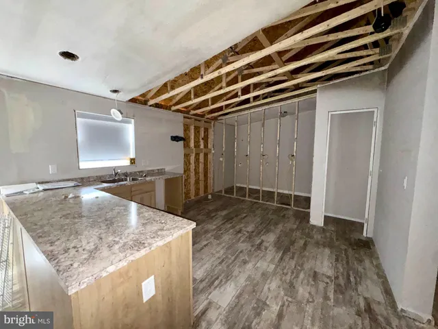 a bathroom with a granite countertop sink and washing machine