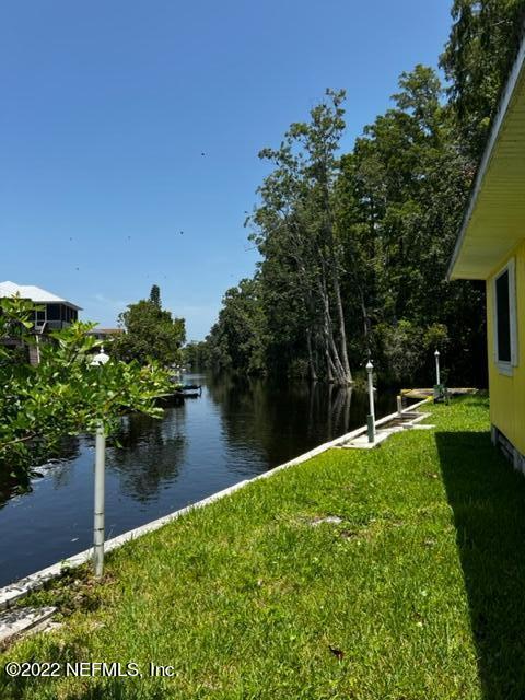 7222 Tropical Drive Weeki Wachee, FL 34607 - Photo 2 of 26 a backyard of a house with lots of green space