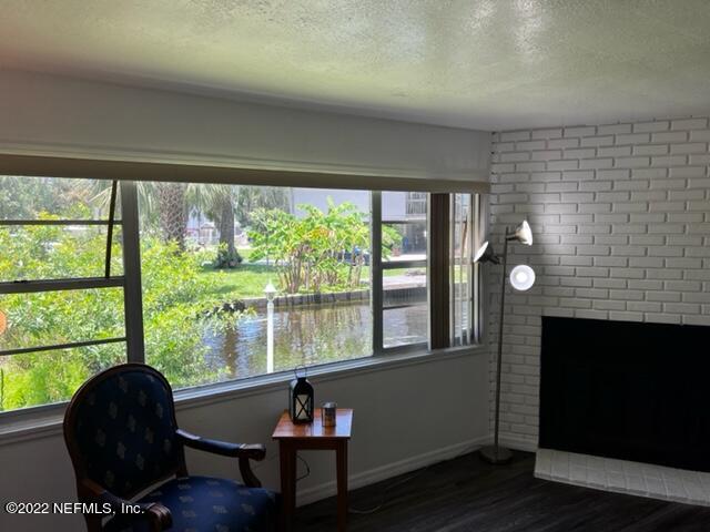 7222 Tropical Drive Weeki Wachee, FL 34607 - Photo 5 of 26 a living room with furniture and a fireplace