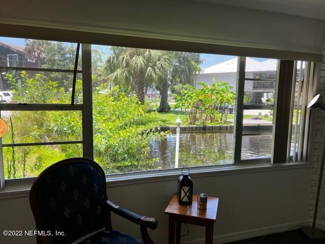 7222 Tropical Drive Weeki Wachee, FL 34607 - Photo 6 of 26 a living room with a large window and a table