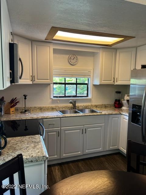 7222 Tropical Drive Weeki Wachee, FL 34607 - Photo 7 of 26 a kitchen with a sink stove and cabinets