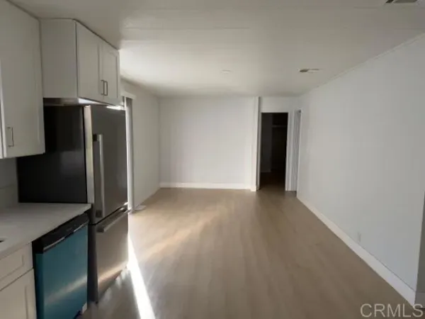 a view of a kitchen with refrigerator and microwave