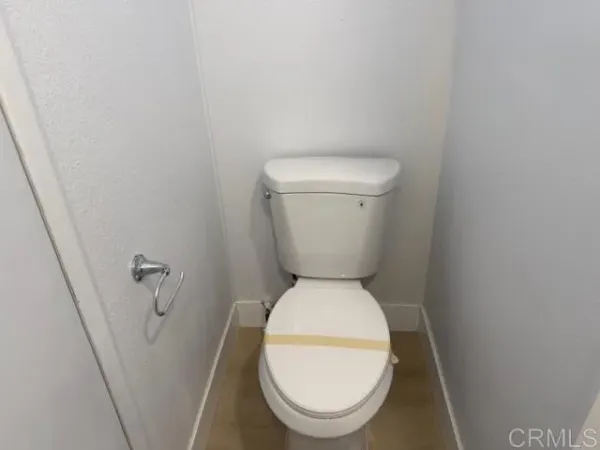 a white toilet sitting next to a sink