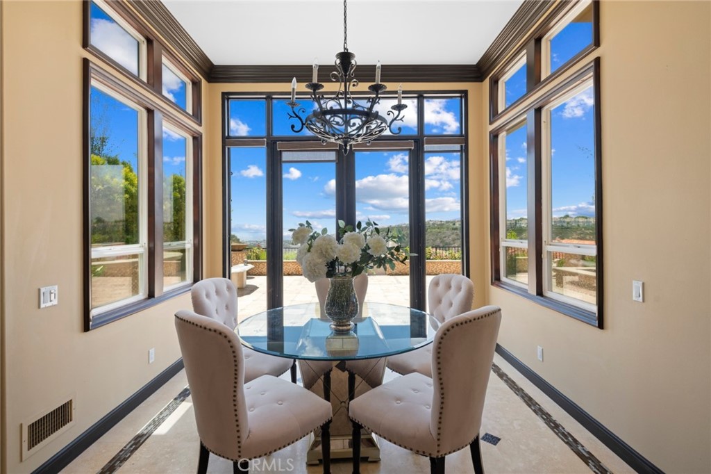 35 Silver Pine Drive Newport Coast, CA 92657 - Photo 12 of 31 a dining room with furniture a chandelier and wooden floor