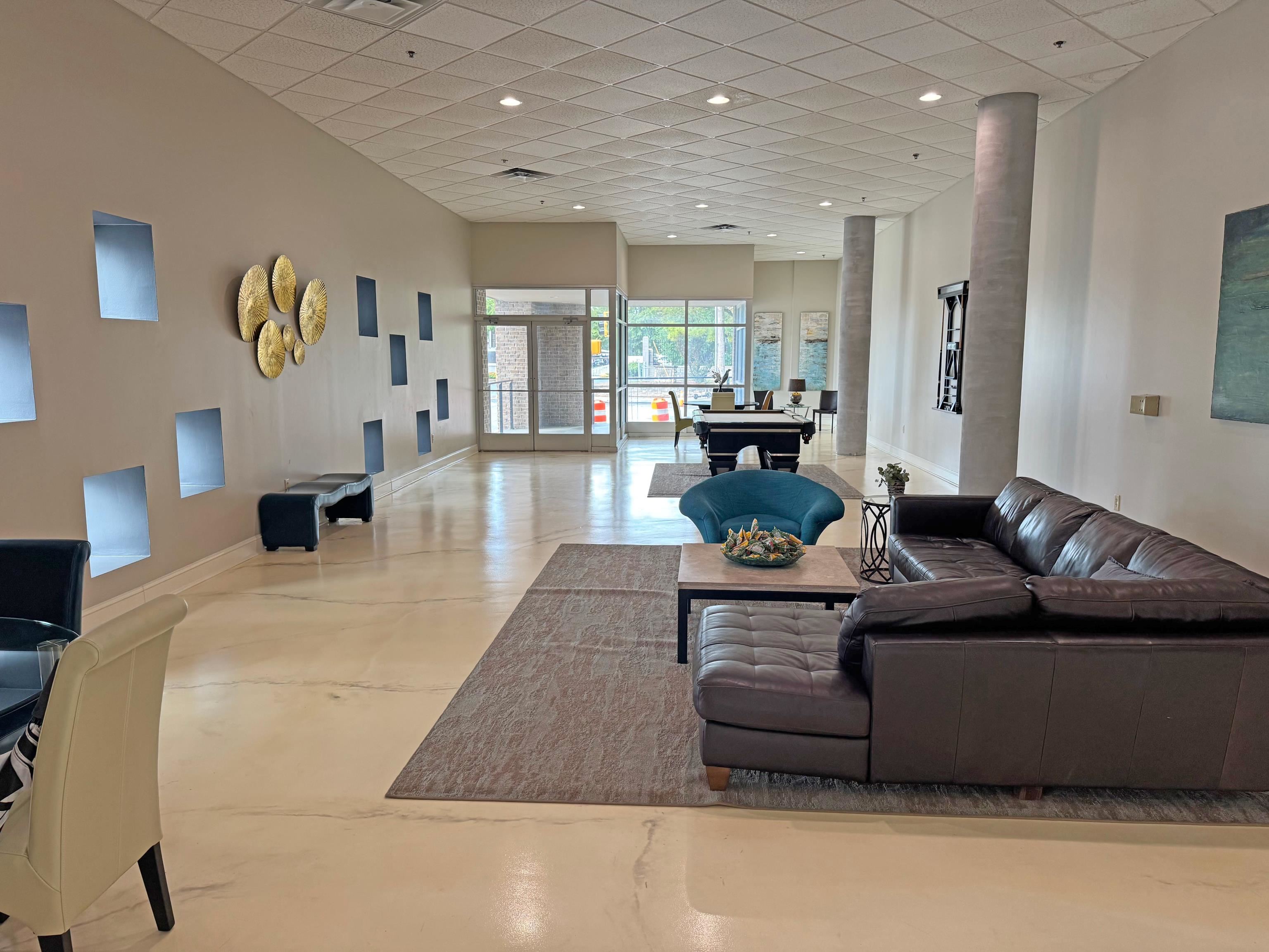 648 Riverside Drive, Unit 309 Memphis, TN 38103 - Photo 11 of 30 a living room with furniture and a wooden floor