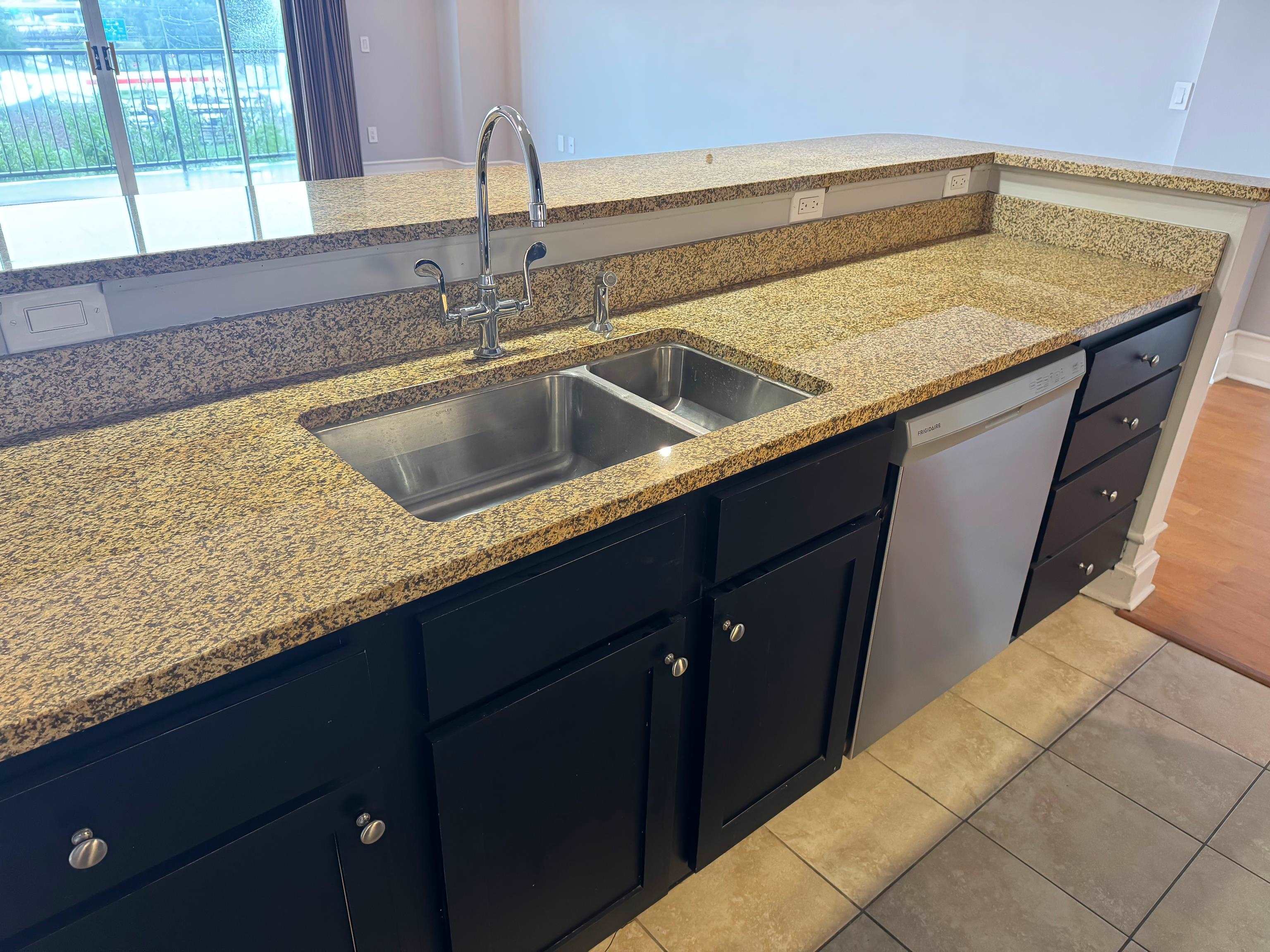 648 Riverside Drive, Unit 309 Memphis, TN 38103 - Photo 15 of 30 a kitchen with a sink and cabinets