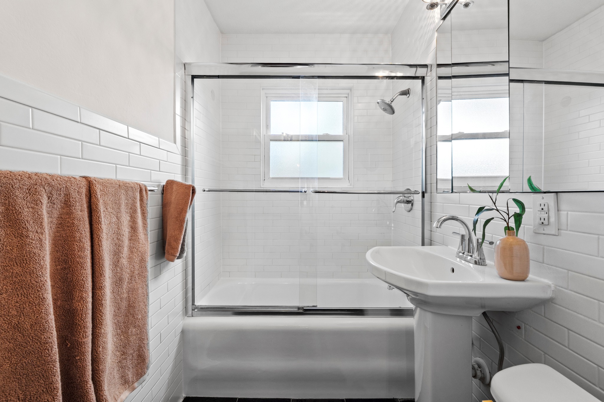 4802 Rowena Avenue Austin, TX 78751 - Photo 19 of 37 Bathroom featuring a pedestal sink, chrome faucet, and subway tile.