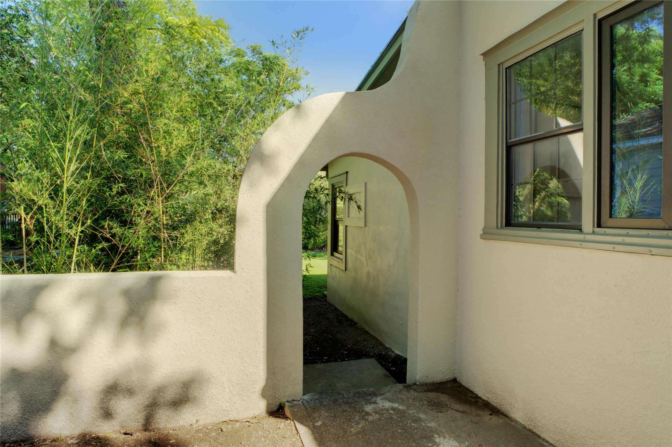 4802 Rowena Avenue Austin, TX 78751 - Photo 34 of 37 Stucco exterior with an arched entry and perimeter wall.