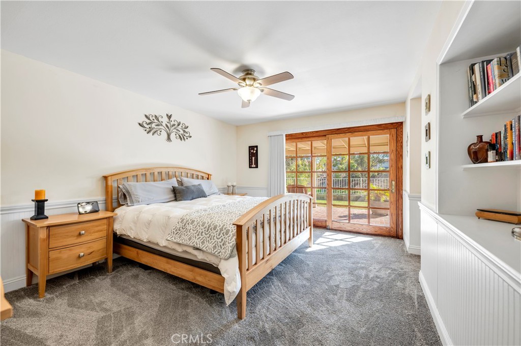 475 Termino Avenue Corona, CA 92879 - Photo 17 of 35 a spacious bedroom with a bed and a chandelier