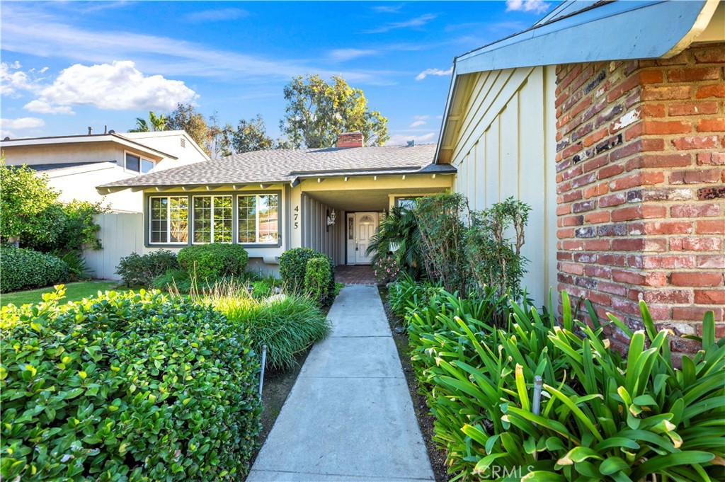 475 Termino Avenue Corona, CA 92879 - Photo 5 of 35 a front view of a house with a yard and potted plants