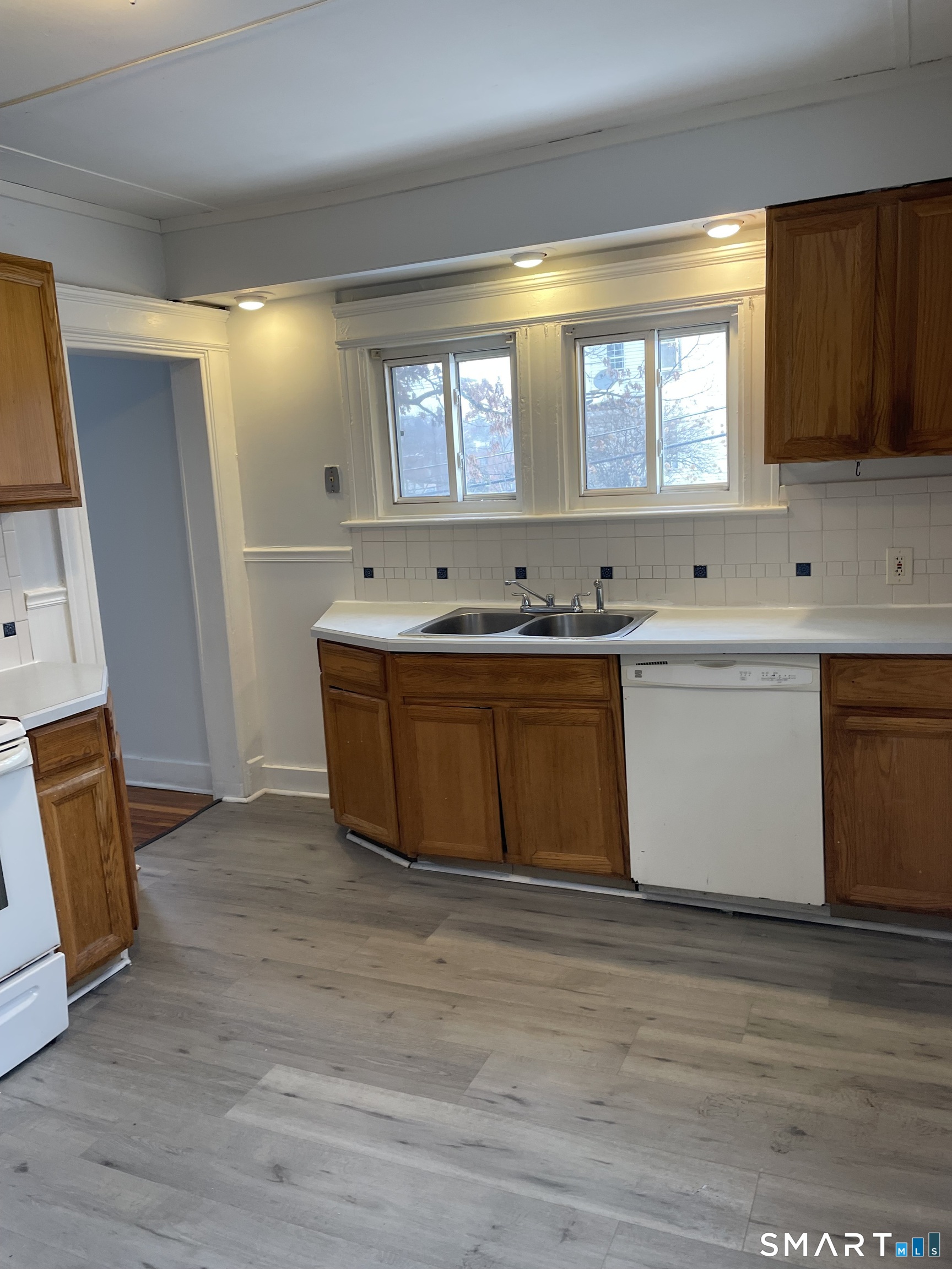 184 Meriden Road Waterbury, CT 06705 - Photo 1 of 14 a view of a kitchen with a sink a window and wooden floor