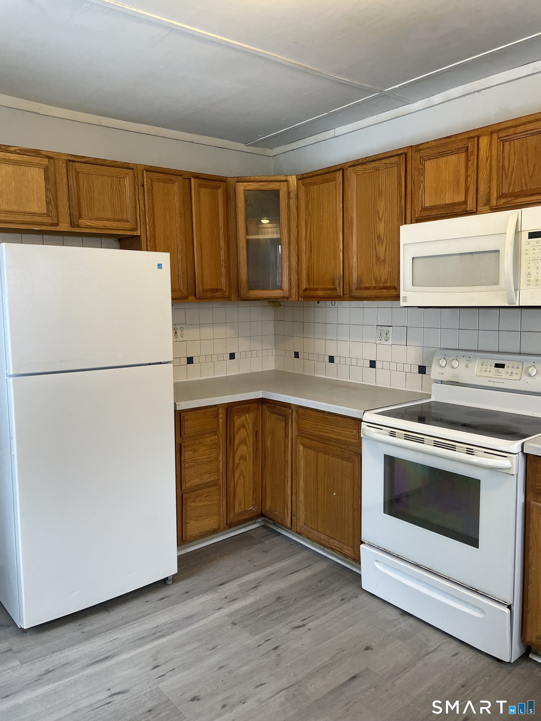 184 Meriden Road Waterbury, CT 06705 - Photo 14 of 14 a kitchen with a refrigerator sink and cabinets