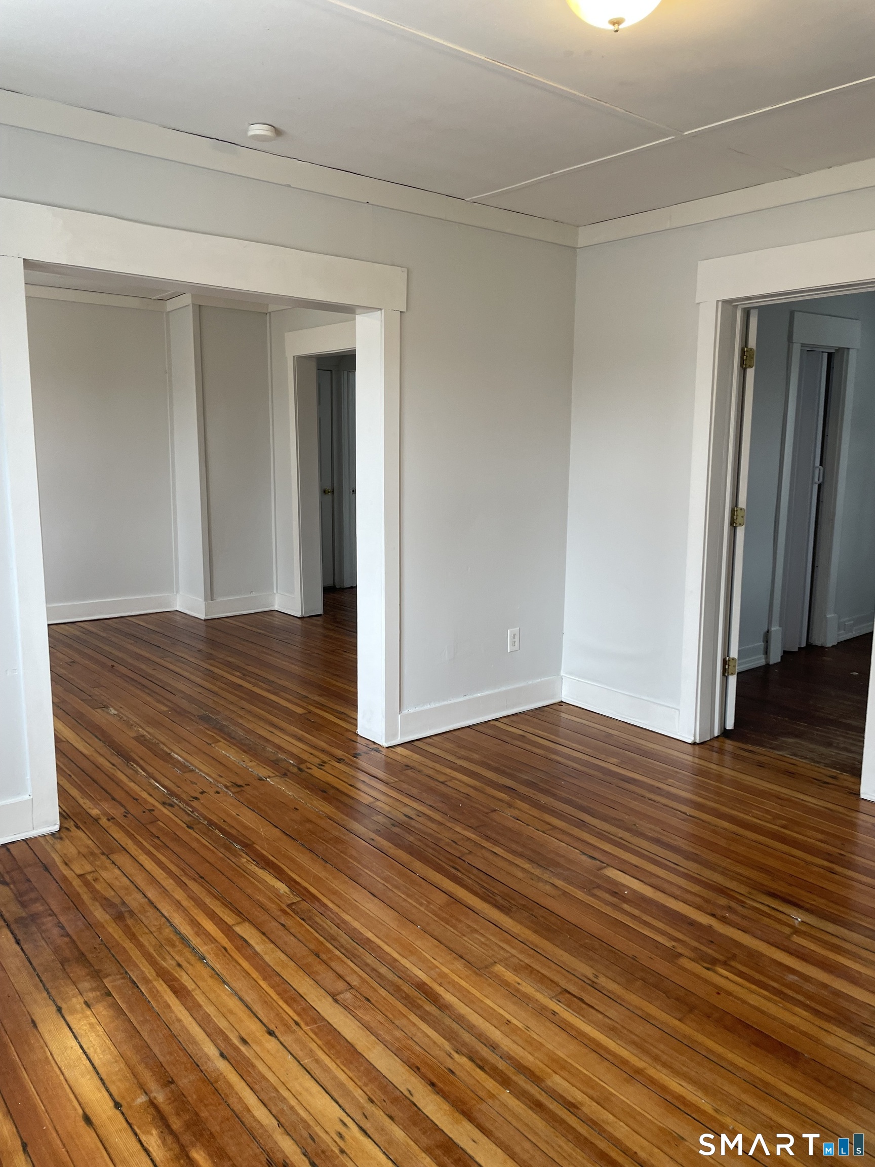 184 Meriden Road Waterbury, CT 06705 - Photo 5 of 14 a view of empty room with wooden floor