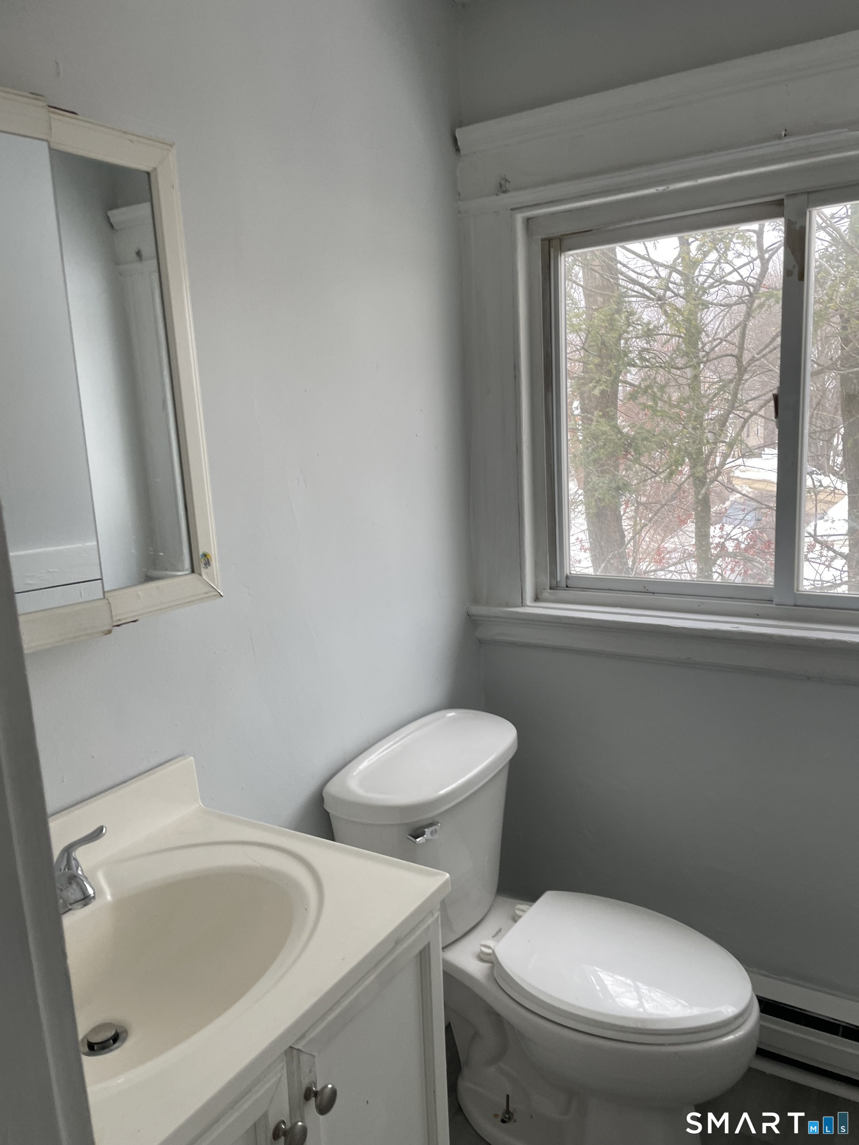184 Meriden Road Waterbury, CT 06705 - Photo 7 of 14 a white toilet sitting next to a window