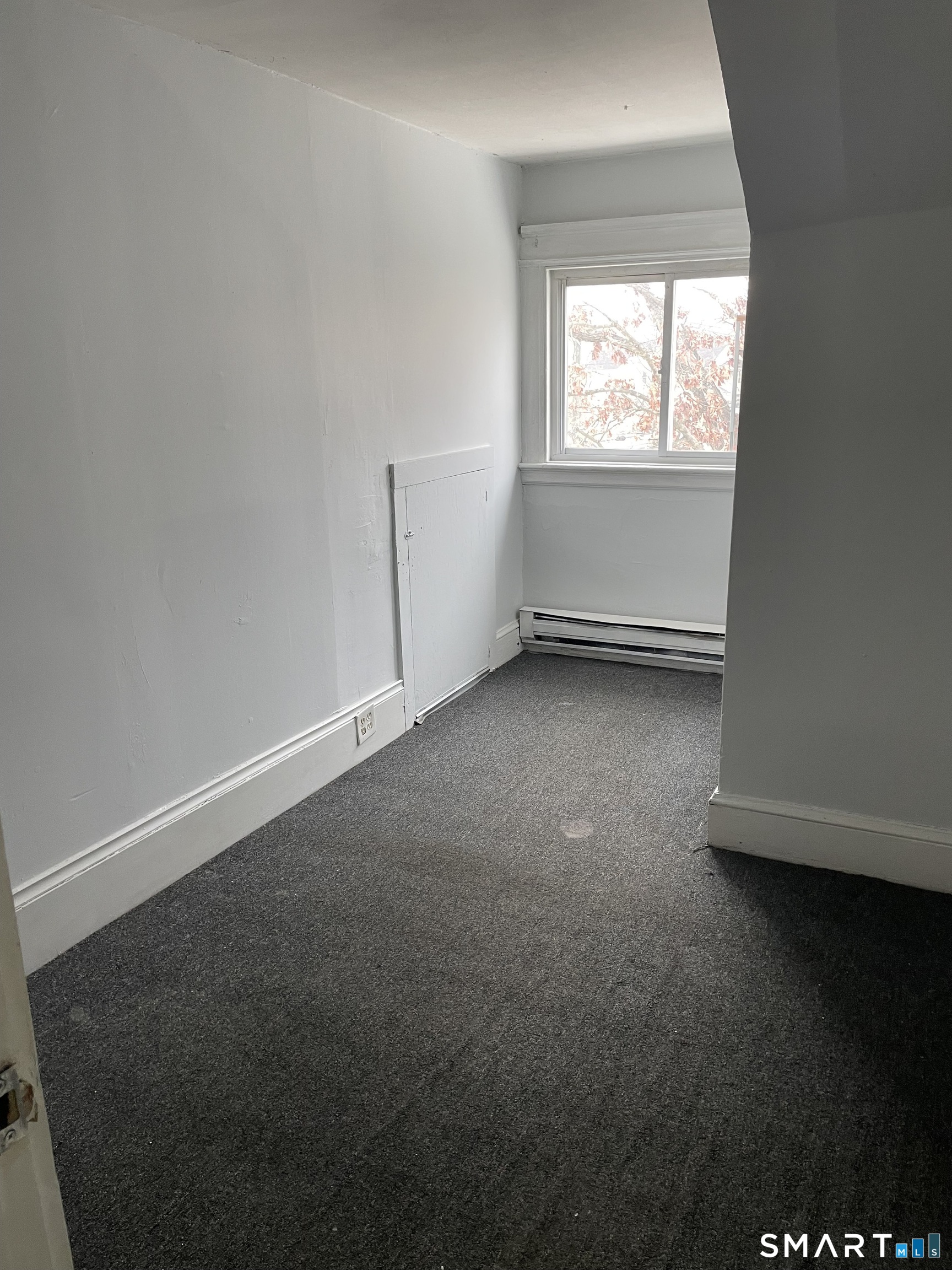 184 Meriden Road Waterbury, CT 06705 - Photo 9 of 14 an empty room with windows