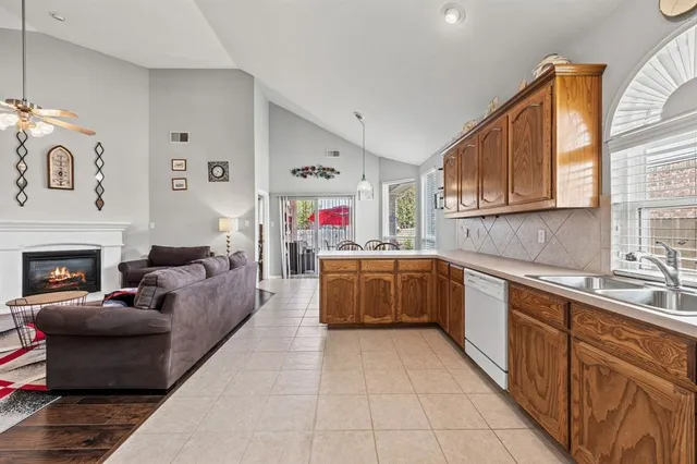 a kitchen with stainless steel appliances granite countertop a stove sink and cabinets